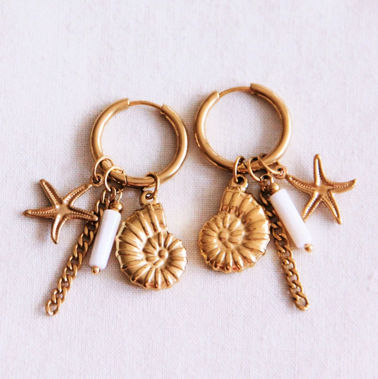 Oorring met schelp, zeester en parelmoer tube